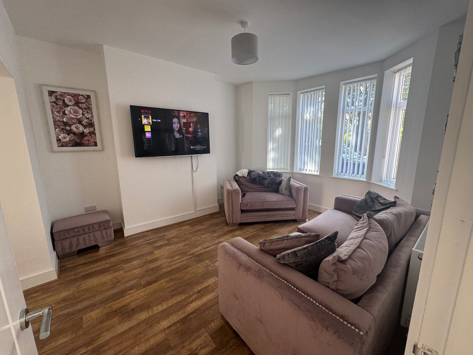 A comfortable living room with soft seating and large windows at a Celestial Care children's home